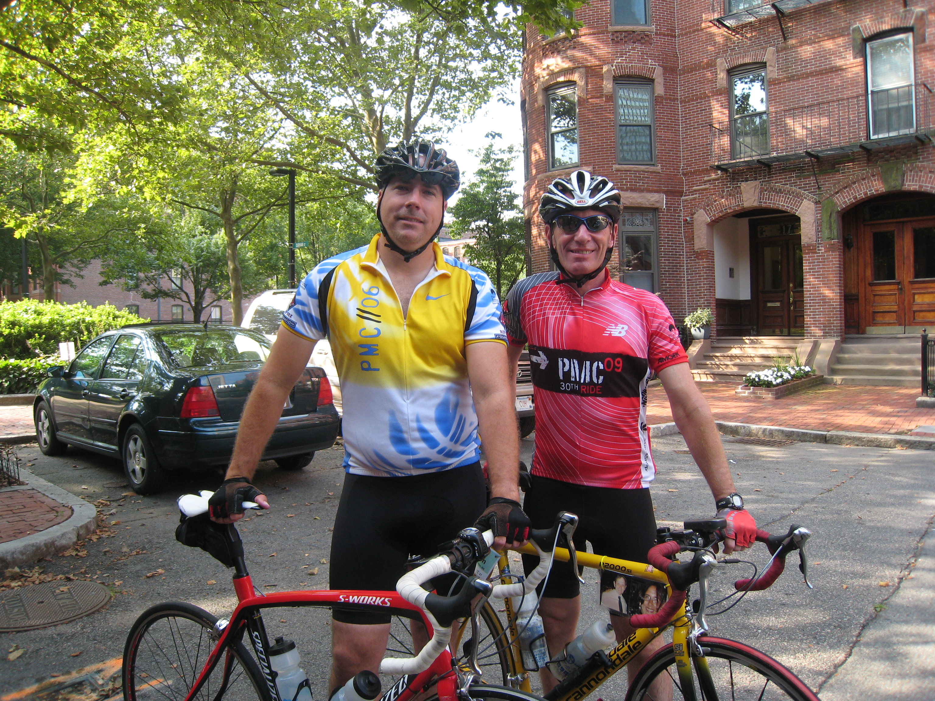Two male PMC riders outside their house