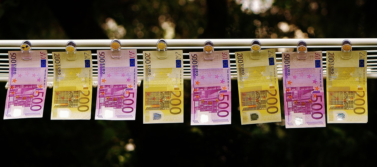 Euro notes hanging from clips attached to a horizontal rod