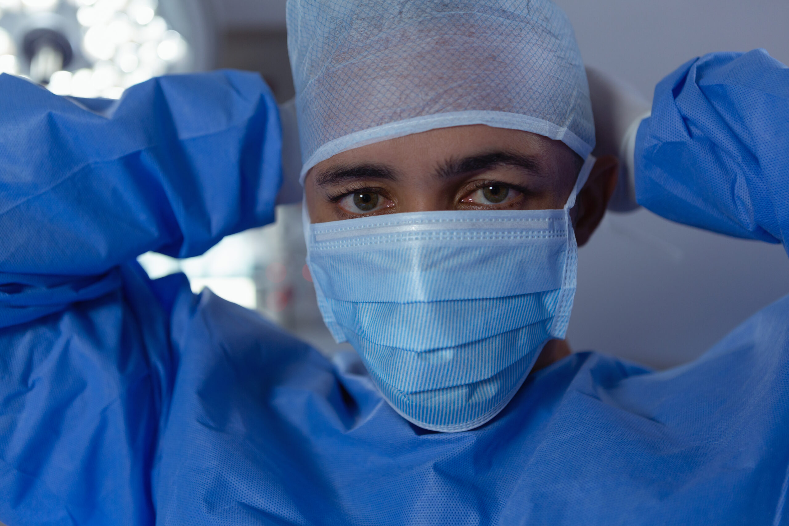 Physician with surgical mask and gown